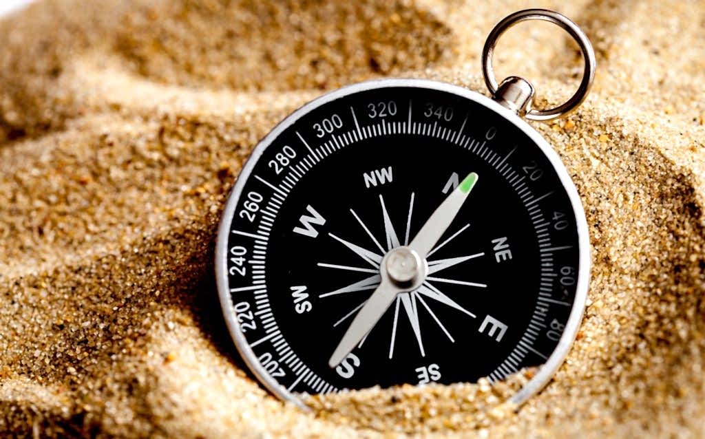 concept compass in sand searching meaning of life close up